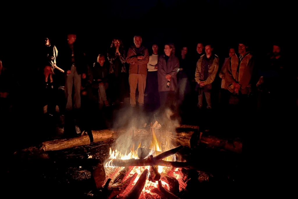 Members of The Art of Hosting and Harvesting Conversations that Matter enjoy time together at the bonfire,